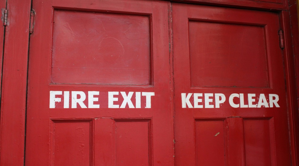 red double fire doors with fire exit keep clear signage